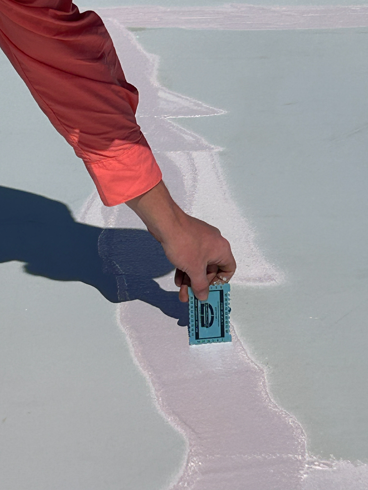 Failed fabric-and-mastic seam patch on a metal roof