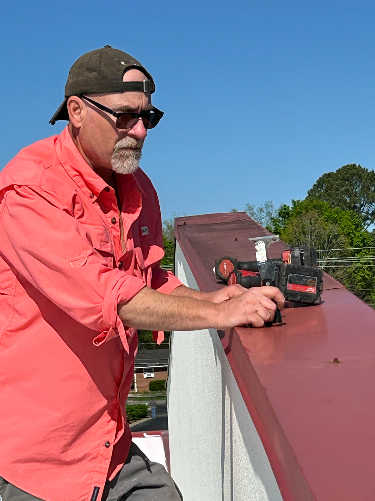 Keith of Volunteer Seamless Systems preparing the top of a parapet wall